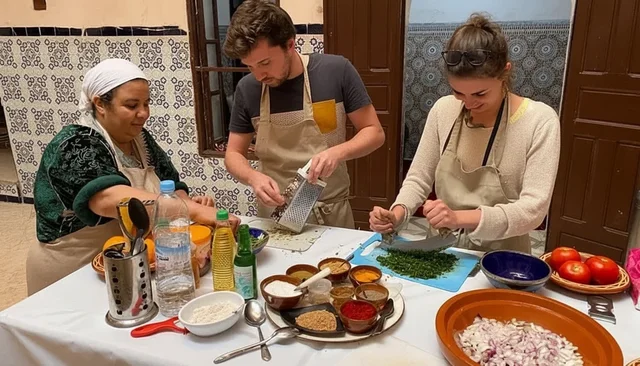 Visitors preparing vegetables during a cookery class